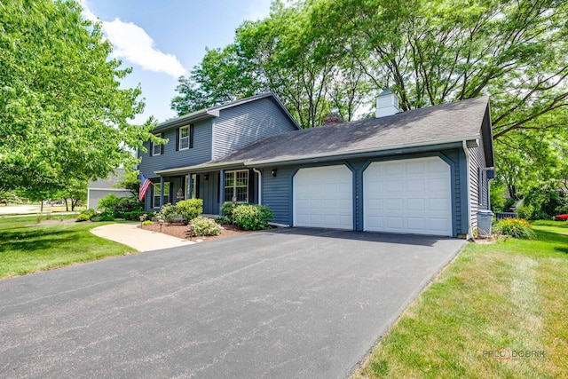 400 Seafarer Dr, Third Lake, IL 60030 - view of front of home with an attached garage, a front lawn, asphalt driveway, and a chimney