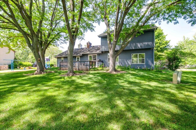 400 Seafarer Dr, Third Lake, IL 60030 - back of house with a deck, a lawn, and a chimney