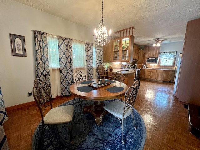 205 E St, Penfield, IL 61862 - dining space with a chandelier, a textured ceiling, and a ceiling fan