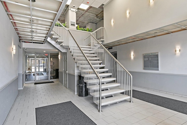 7234 W N Ave Unit 1203, Elmwood Park, IL 60707 - stairs featuring a towering ceiling and tile patterned flooring