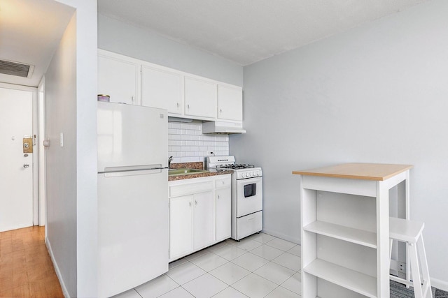 7234 W N Ave Unit 1203, Elmwood Park, IL 60707 - kitchen with white appliances, decorative backsplash, white cabinets, under cabinet range hood, and dark countertops