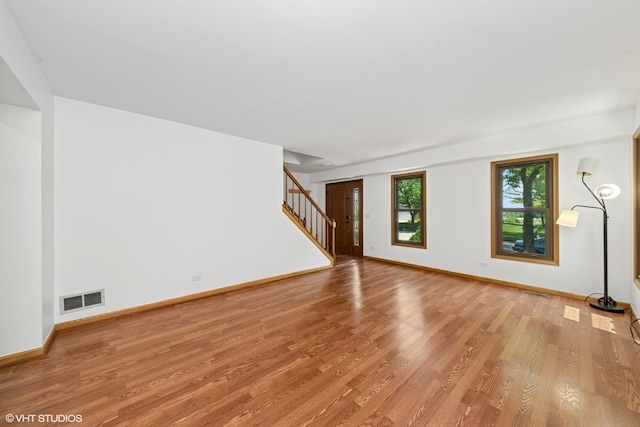 600 N Brookdale Dr, Schaumburg, IL 60194 - unfurnished living room featuring light wood-style floors and stairway