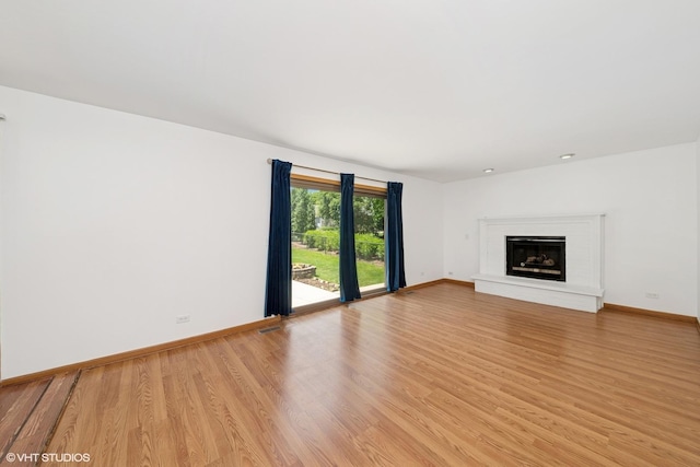 600 N Brookdale Dr, Schaumburg, IL 60194 - unfurnished living room with light wood finished floors and a fireplace with raised hearth
