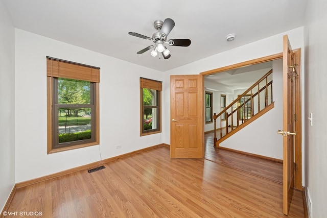 600 N Brookdale Dr, Schaumburg, IL 60194 - spare room with light wood-style floors, ceiling fan, stairway, and a smoke detector