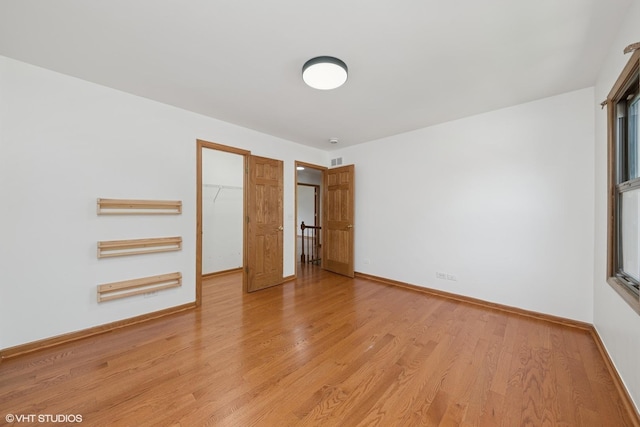 600 N Brookdale Dr, Schaumburg, IL 60194 - unfurnished bedroom with light wood-type flooring, a closet, and a spacious closet