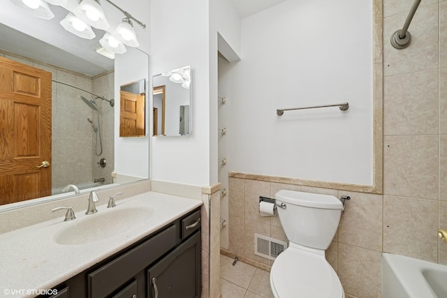 600 N Brookdale Dr, Schaumburg, IL 60194 - bathroom featuring tile walls, vanity, tile patterned floors, bathing tub / shower combination, and a wainscoted wall