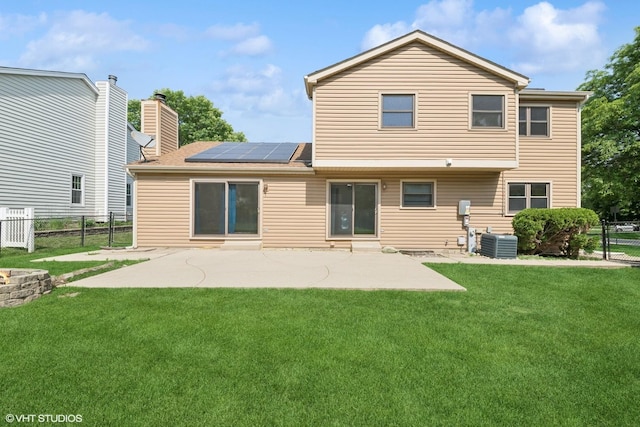 600 N Brookdale Dr, Schaumburg, IL 60194 - back of house with solar panels, a patio area, a fenced backyard, a chimney, and a shingled roof