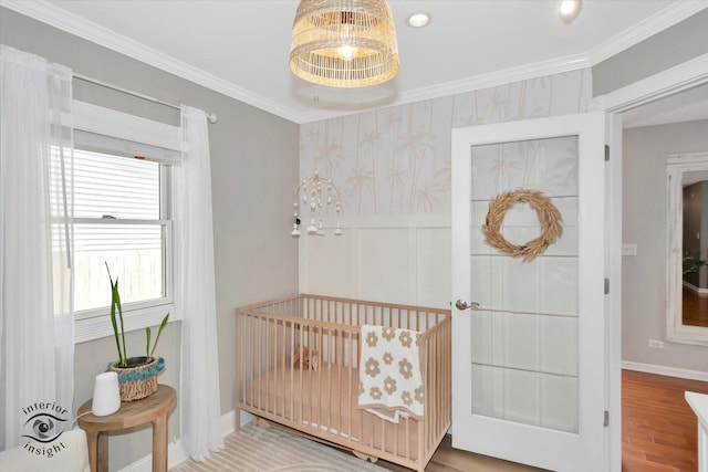 16838 S 91st Ave, Orland Hills, IL 60487 - bedroom featuring crown molding, a crib, wood finished floors, wallpapered walls, and a decorative wall