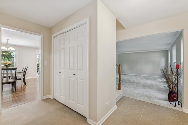 5618 Marietta Dr, Crystal Lake, IL 60014 - hallway featuring tile patterned floors, a chandelier, and carpet floors
