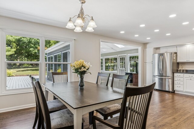 5618 Marietta Dr, Crystal Lake, IL 60014 - dining space featuring a chandelier, recessed lighting, dark wood-style floors, a skylight, and bar