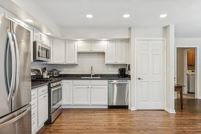 5618 Marietta Dr, Crystal Lake, IL 60014 - kitchen featuring stainless steel appliances, washer / clothes dryer, dark wood-style floors, white cabinets, and recessed lighting