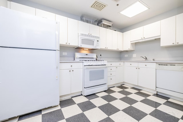 21 W Chestnut St Unit 907, Chicago, IL 60610 - kitchen featuring white appliances, light floors, light countertops, and white cabinetry