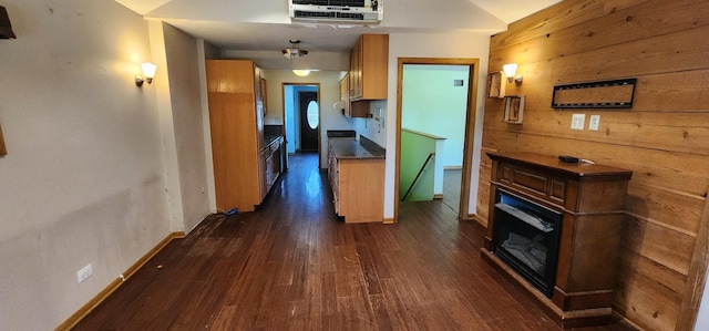 504 W Avery St, Elmhurst, IL 60126 - kitchen with a glass covered fireplace, dark wood-style floors, wooden walls, and brown cabinetry