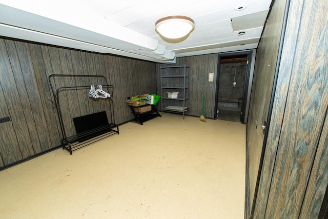 finished below grade area featuring wooden walls
