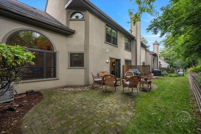 1242 Hobson Oaks Dr, Naperville, IL 60540 - rear view of house featuring a patio area, stucco siding, and a chimney