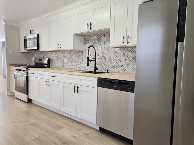 16536 Wolcott Ave, Markham, IL 60428 - kitchen with stainless steel appliances, backsplash, wood counters, and crown molding