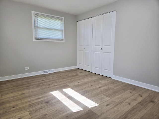 16536 Wolcott Ave, Markham, IL 60428 - unfurnished bedroom featuring wood finished floors and a closet