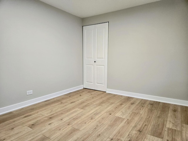 16536 Wolcott Ave, Markham, IL 60428 - unfurnished bedroom featuring light wood-style floors and a closet