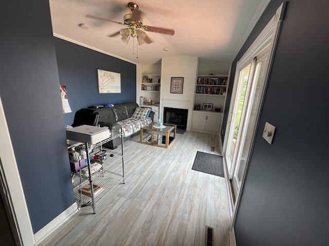 18367 US-150 Hwy, Bloomington, IL 61705 - living room with lofted ceiling, wood finished floors, built in features, a textured ceiling, and ceiling fan
