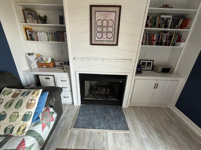 18367 US-150 Hwy, Bloomington, IL 61705 - sitting room featuring light wood-style floors, built in shelves, and a fireplace