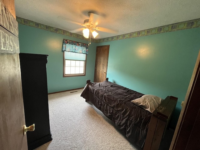 18367 US-150 Hwy, Bloomington, IL 61705 - carpeted bedroom with a textured ceiling and ceiling fan