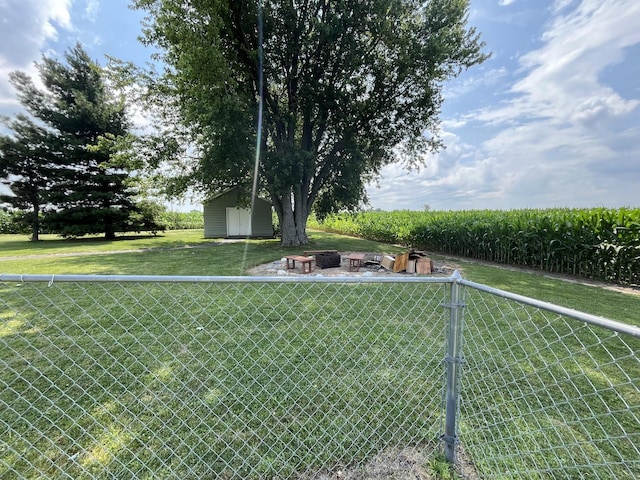 18367 US-150 Hwy, Bloomington, IL 61705 - view of yard featuring an outdoor fire pit, agricultural plots, a storage unit, and a view of rural / pastoral area