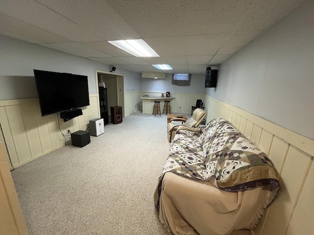 18367 US-150 Hwy, Bloomington, IL 61705 - living room featuring a wainscoted wall, a drop ceiling, and carpet flooring