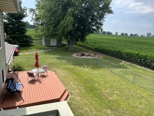 18367 US-150 Hwy, Bloomington, IL 61705 - fenced backyard with agricultural area, a wooden deck, outdoor dining space, a view of rural / pastoral area, and a fire pit
