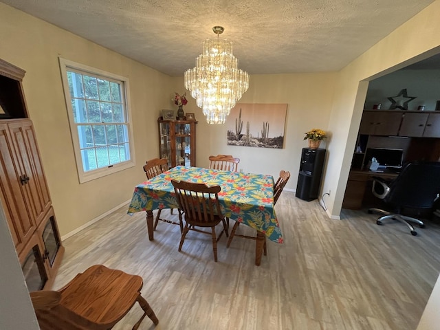 18367 US-150 Hwy, Bloomington, IL 61705 - dining space featuring light wood-style floors, a chandelier, a textured ceiling, and an office area