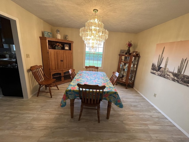 18367 US-150 Hwy, Bloomington, IL 61705 - dining space with light wood-type flooring, a chandelier, and a textured ceiling