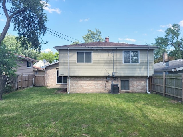 14326 Irving Ave, Dolton, IL 60419 - back of house with a fenced backyard, a chimney, and brick siding