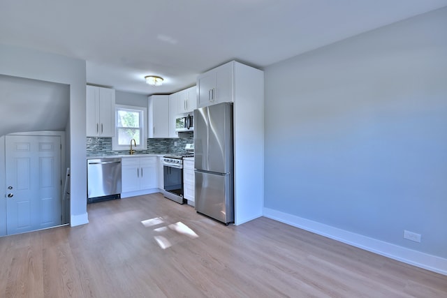 2024 S 24th Ave, Broadview, IL 60155 - kitchen with appliances with stainless steel finishes, light wood-style flooring, white cabinets, and tasteful backsplash