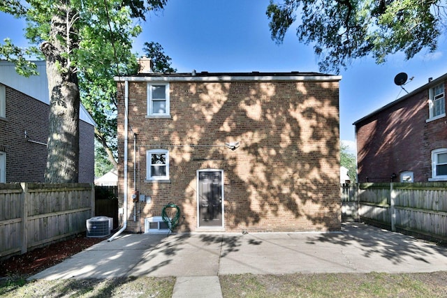 2024 S 24th Ave, Broadview, IL 60155 - rear view of house featuring a patio area, brick siding, and a chimney