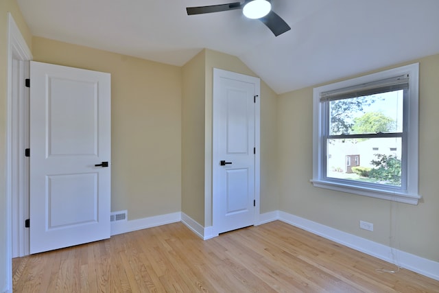 2024 S 24th Ave, Broadview, IL 60155 - unfurnished bedroom with light wood-style flooring, vaulted ceiling, and ceiling fan