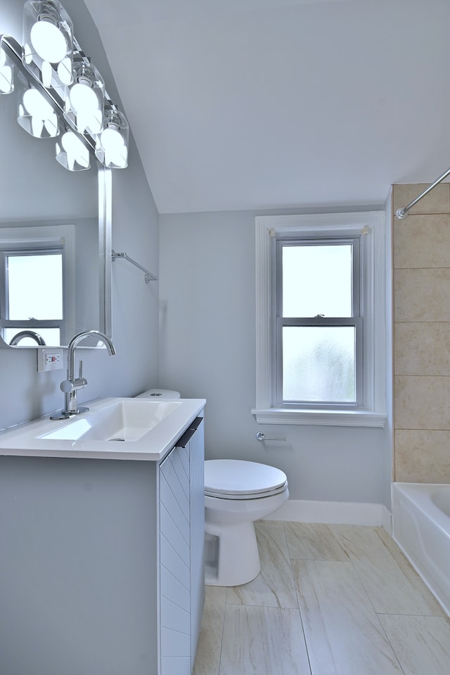 2024 S 24th Ave, Broadview, IL 60155 - bathroom with vanity, bathtub / shower combination, plenty of natural light, and vaulted ceiling