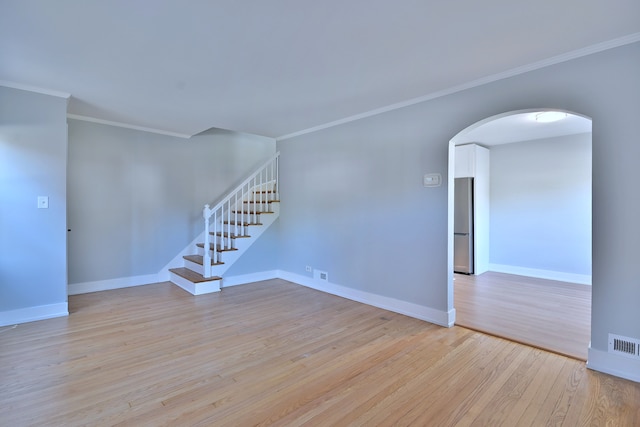 2024 S 24th Ave, Broadview, IL 60155 - empty room with arched walkways, light wood-style floors, stairs, and crown molding