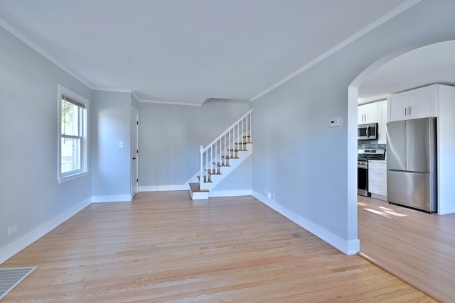 2024 S 24th Ave, Broadview, IL 60155 - entrance foyer featuring arched walkways, light wood-style flooring, ornamental molding, and stairway