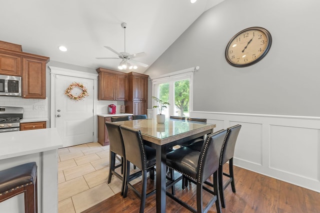14301 S California Ave, Posen, IL 60469 - dining area featuring a ceiling fan, vaulted ceiling, wainscoting, recessed lighting, and a decorative wall