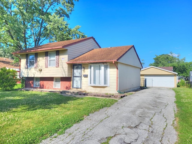 127 N Cedar Ln, Glenwood, IL 60425 - tri-level home featuring a garage, an outbuilding, and a front lawn