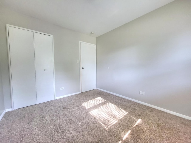 127 N Cedar Ln, Glenwood, IL 60425 - unfurnished bedroom featuring carpet flooring and a closet