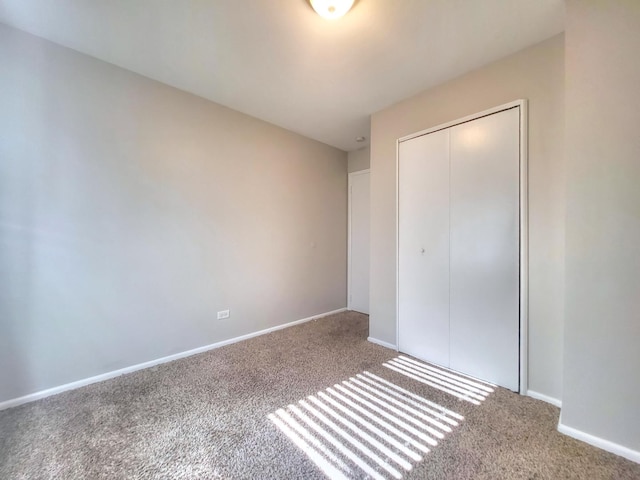 127 N Cedar Ln, Glenwood, IL 60425 - unfurnished bedroom with carpet floors and a closet