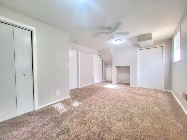 127 N Cedar Ln, Glenwood, IL 60425 - unfurnished bedroom featuring two closets, carpet floors, lofted ceiling, and a ceiling fan