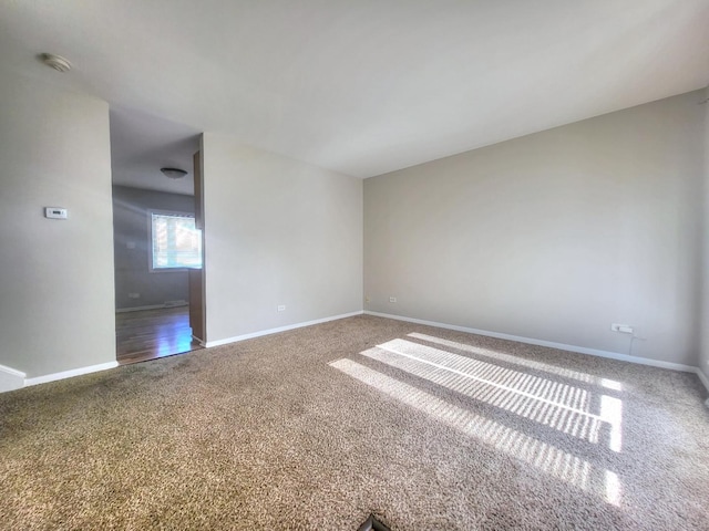 127 N Cedar Ln, Glenwood, IL 60425 - carpeted spare room featuring baseboards and a smoke detector