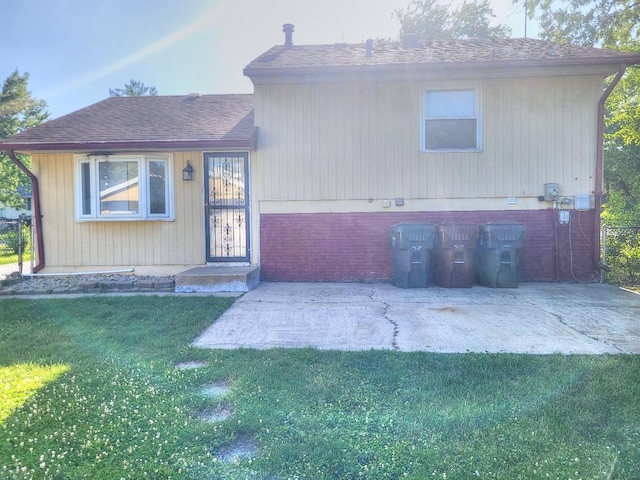 127 N Cedar Ln, Glenwood, IL 60425 - view of front of property featuring a front yard, roof with shingles, and a patio