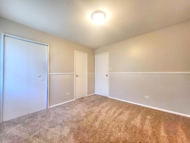 127 N Cedar Ln, Glenwood, IL 60425 - unfurnished bedroom featuring carpet flooring and a closet