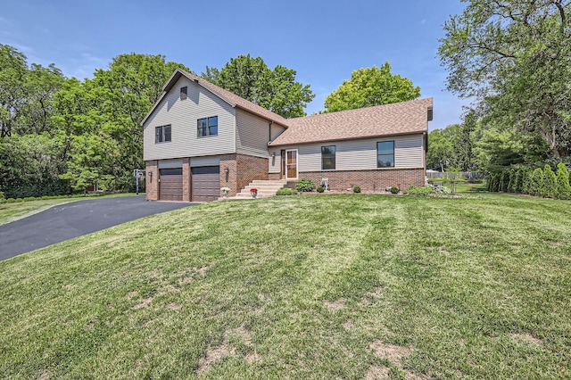 1718 Rosewood Ln, Johnsburg, IL 60051 - split level home featuring brick siding, an attached garage, asphalt driveway, and a front lawn