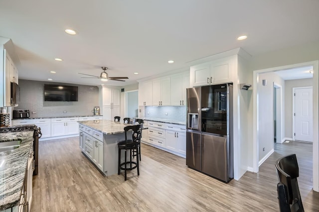 1718 Rosewood Ln, Johnsburg, IL 60051 - kitchen with stainless steel fridge, decorative backsplash, white cabinetry, ceiling fan, and recessed lighting