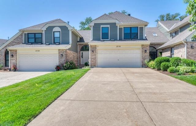 2716 Burton Dr, Westchester, IL 60154 - view of front facade with an attached garage, driveway, a front lawn, and brick siding