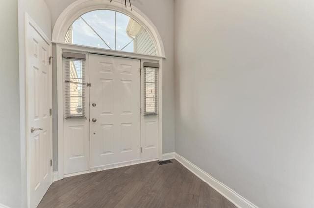 2716 Burton Dr, Westchester, IL 60154 - entryway featuring baseboards and dark wood finished floors