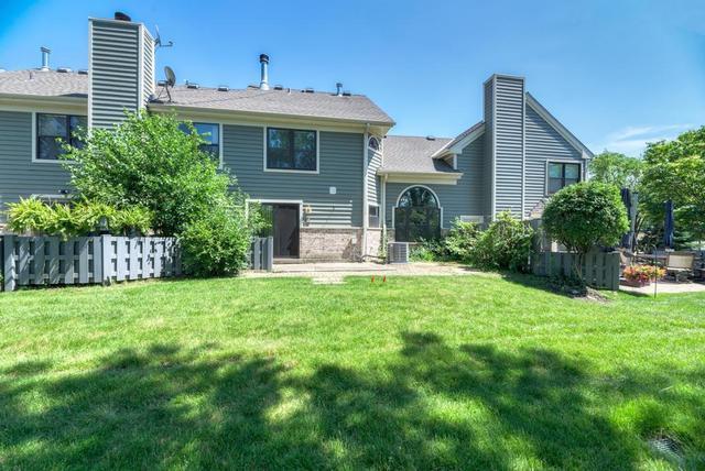 2716 Burton Dr, Westchester, IL 60154 - rear view of property featuring a chimney and a lawn